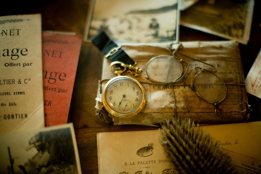 Magnifying glass over old documents and a pocket watch