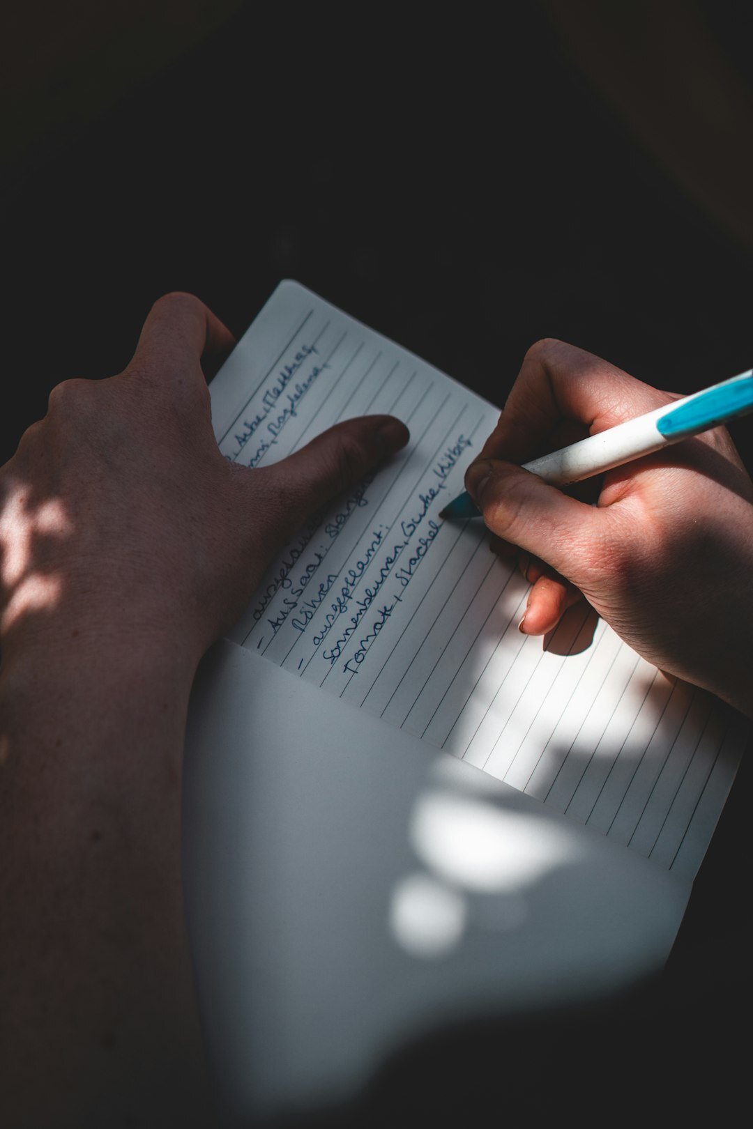 person writing in notebook