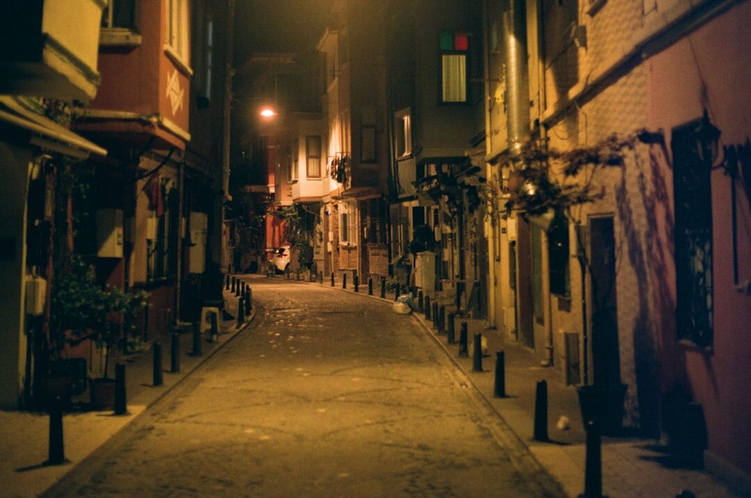 Foggy cobblestone street in an old European town at night